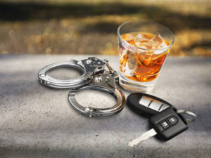 an alcoholic drink, a set of handcuffs, and a pair of car keys
